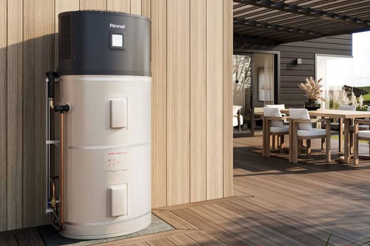 Outdoor hot water heat pump unit next to a wooden deck with a table and chairs.